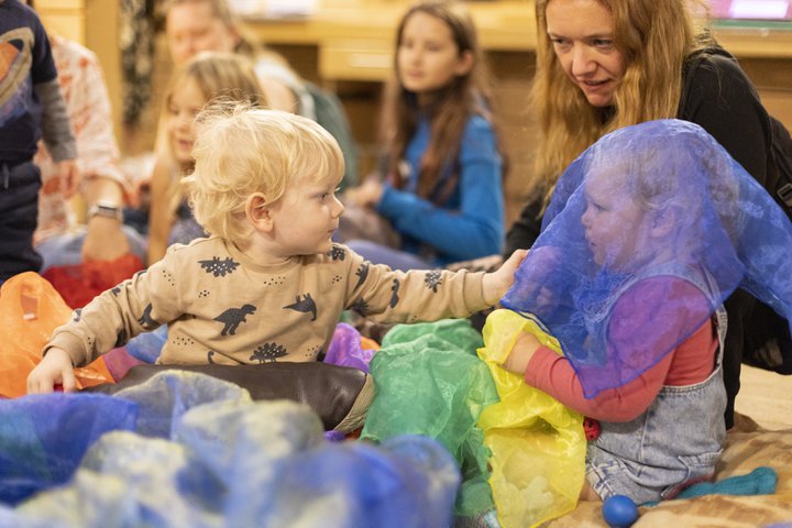 Toddlers at a play station with tactile items