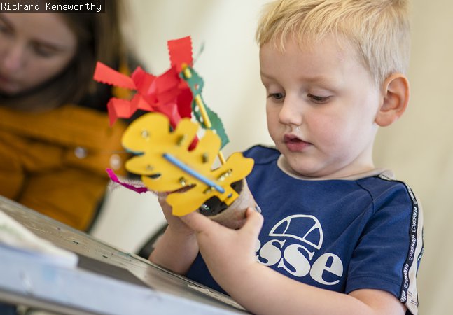 A young boy crafting paper 
