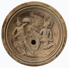 Roman terracotta lamp showing outline of two gladiators in combat 