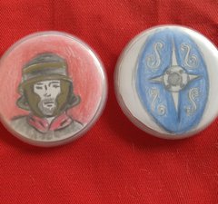Two handmade button badges