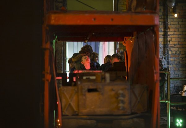 Primary school child looking at large mining equipment