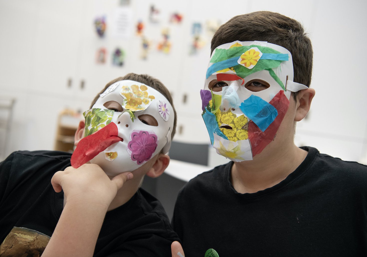 Two children are making masks.