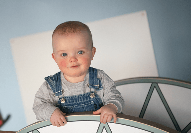 Let's Play Child looking into camera smiling