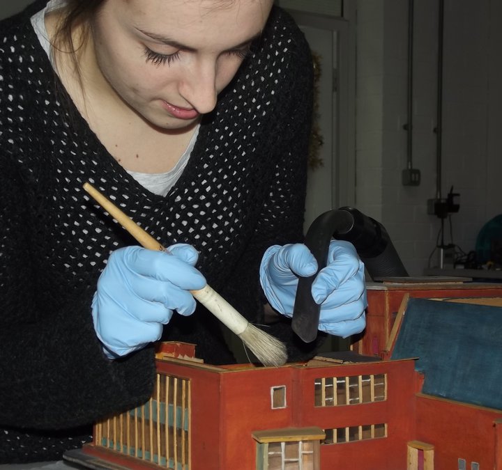Conservation team cleaning a model