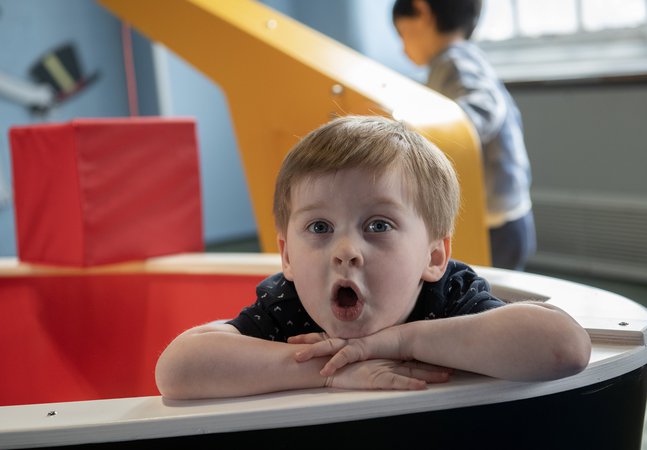 little boy playing in the museum