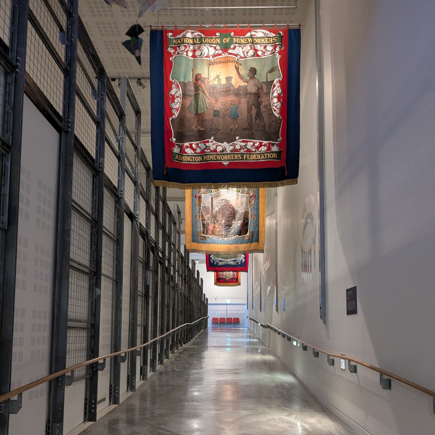Mining banners hung over a ramped walkway in Woodhorn Museum.