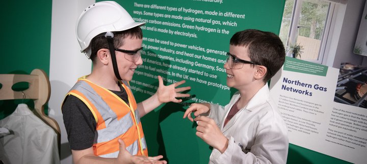two boys talk animatedly in Steam to Green space
