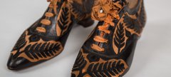 1800s black and orange lace up shoes.