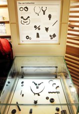 Display case containing objects made from jet