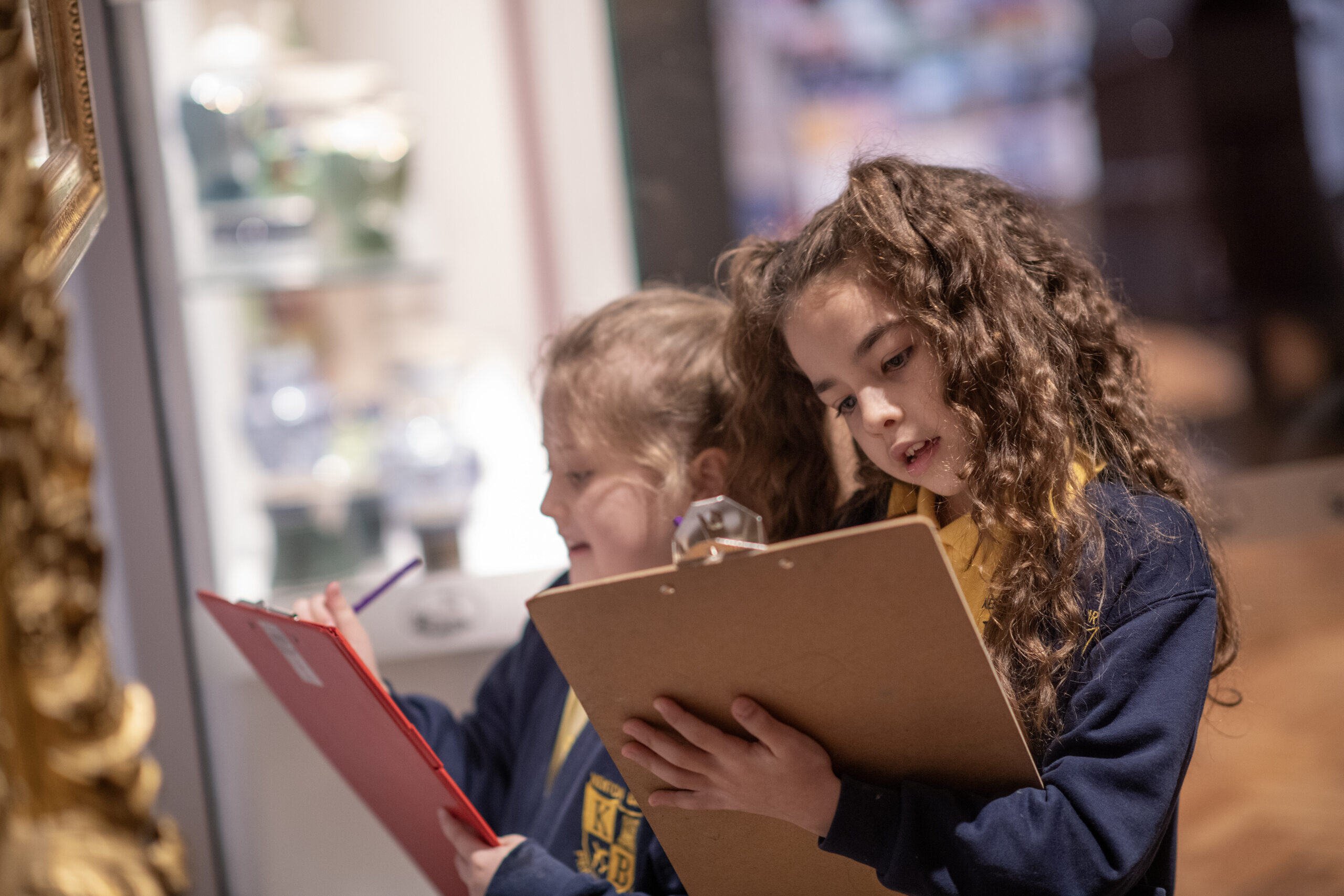 Schoolchildren drawing in an art gallery.