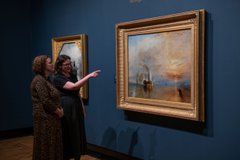 A photograph of two women looking at The Fighting Temeraire