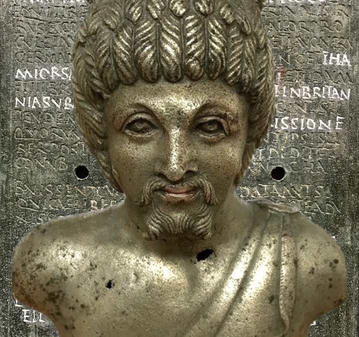 A metal vessel, designed in the shape of a male head and shoulders.