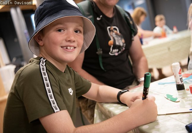 smiling boy at table in Discovery Museum