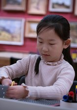 A photograph of a young girl crafting.